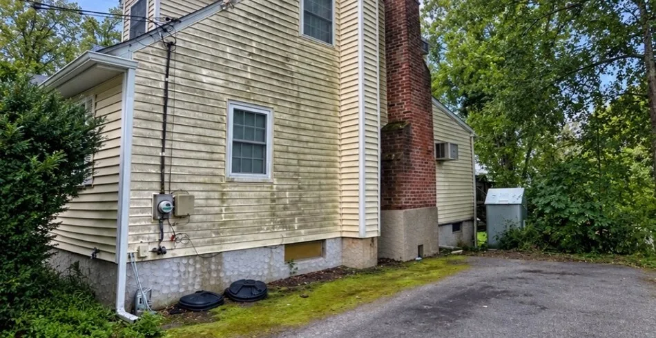 Vinyl siding with mildew and green growth before soft washing, Westchester NY